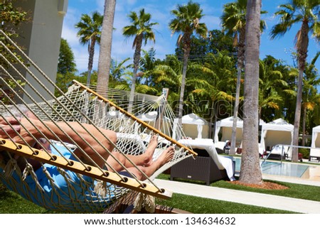 white male relaxing in hammock.