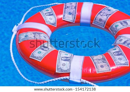 saving money concept with copy space. Buoy with american currency on it in swimming pool. Horizontal shot.