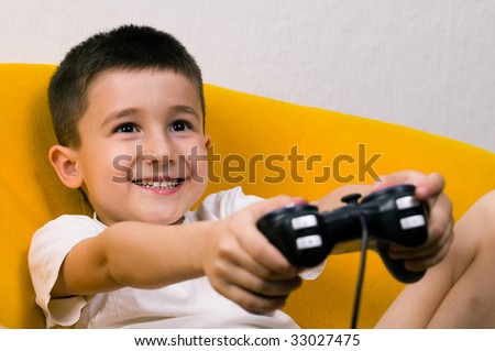 A young boy playing a computer game.