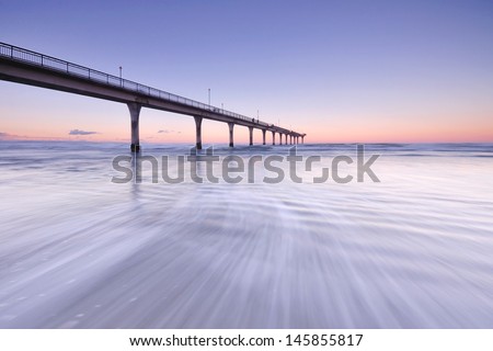Sunset and wave flow in New Brighton Pier, Christchurch New Zealand