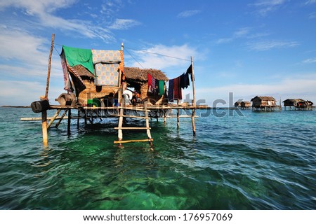 SEMPORNA, MALAYSIA - SEPTEMBER 17 : Unidentified sea gypsy family in their house on September 17, 2011 in Semporna, Sabah, Malaysia. Sea gypsies is an indigenous ethnic group in Sabah, Malaysia.