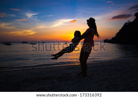 Silhouette of mother and little daughter on Boracay, Philippines