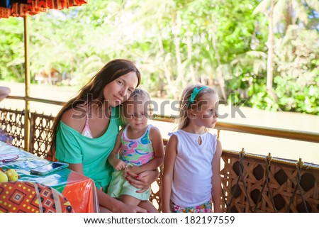 Mom with little girls on the ferry ride to the Philippines Loboc River