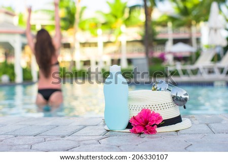 Woman, suncream, hat, sunglasses, flower and tower near swimming pool
