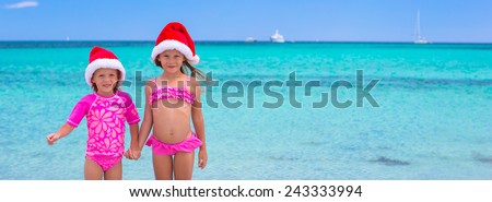 Little girls in Santa hats during summer vacation