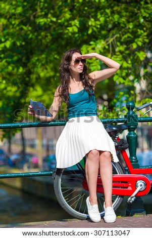 Young beautiful woman on bike in european city