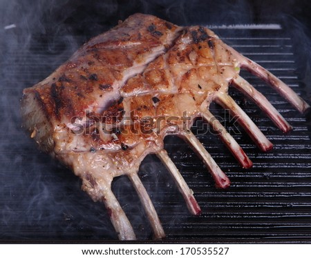 Tasty rack of lamb/Rack of lamb/A tasty rack of lamb grilling in a heavy pan.