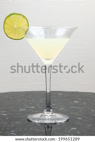 Classic Rum Daiquiri/A Classic Rum Daiquiri Cocktail/A photo of a Classic Rum Daiquiri Cocktail on a granite tabletop with textured cream wallpaper background.