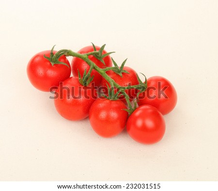 Ripe juicy tomatoes/Juicy Vine Tomatoes/A photo of juicy and ripe vine tomatoes shot on a textured beige color canvas tablecloth. Shot in Studio.