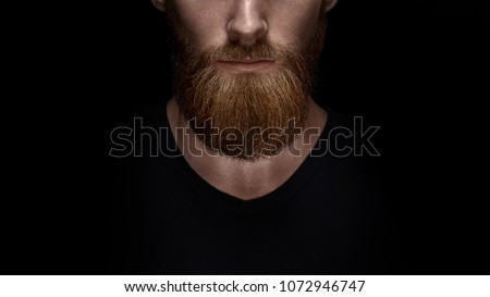 Perfect beard. Close-up of young bearded man standing against black background ストックフォト © 