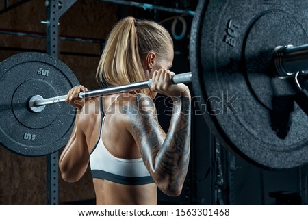 Similar – Image, Stock Photo Focused sportswoman doing squats with elastic band in apartment