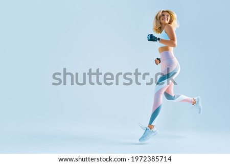 Image, Stock Photo Attractive sportswoman standing and listening music on the street