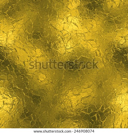 Golden Foil luxury seamless and tileable background texture. Glittering holiday wrinkled gold background and shiny bright metal surface backdrop.