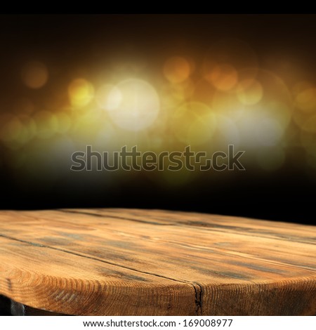 desk of wood with golden lights in dark space