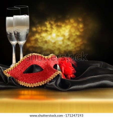 gold bokeh and red mask with champagne