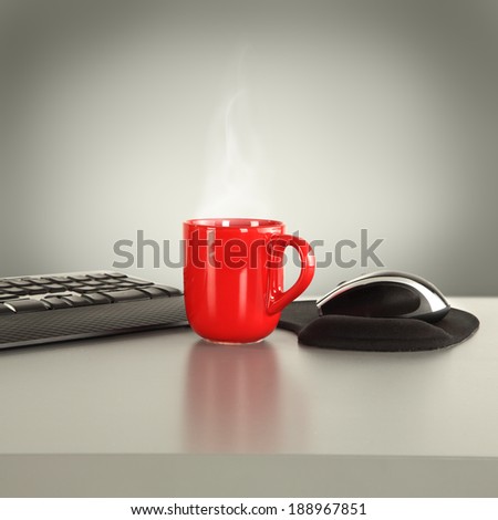warm red mug on desk