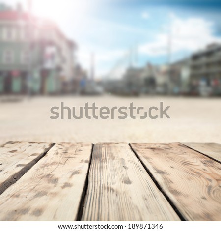 wooden table and city space with sun