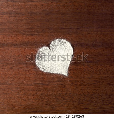 old dark brown desk in kitchen and white flour heart