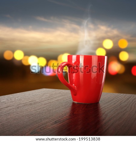 dark brown desk and red mug space in night