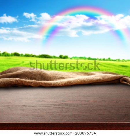 dark brown desk and sky with rainbow of free space