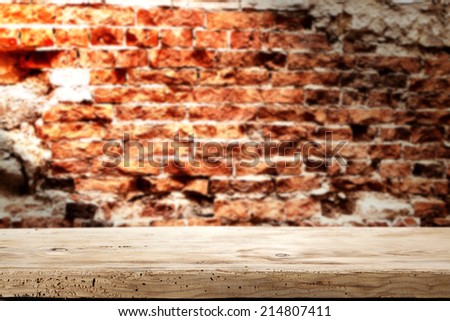 worn yellow  desk of wood with bricks wall