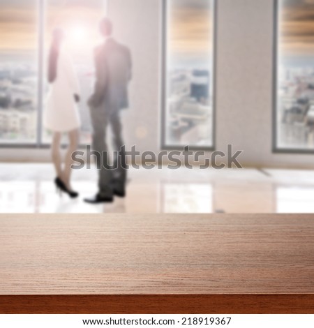 brown desk of wood with two people in window
