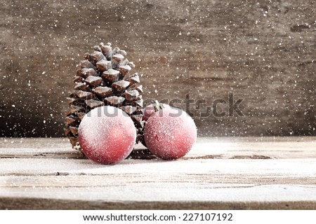 holiday decoration on wooden sill and red balls and brown cone space