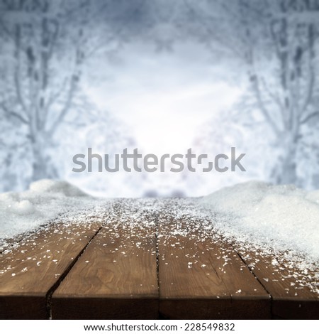 blue landscape of winter and snow on wooden brown table