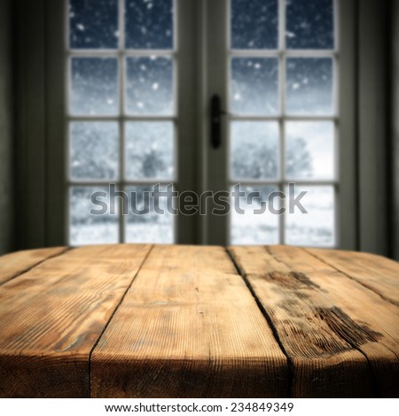 old wooden big table in interior with big window