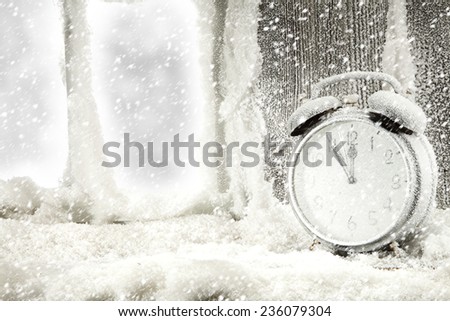 clock and snow on window