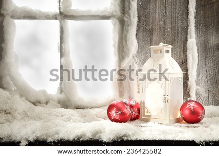red balls and lamp on window sill and frost space