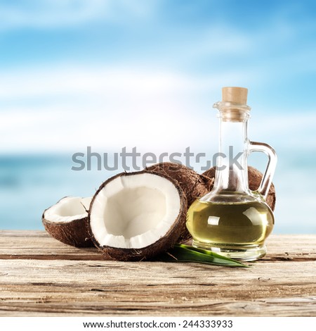 shells of cocnuts and oil in bottle