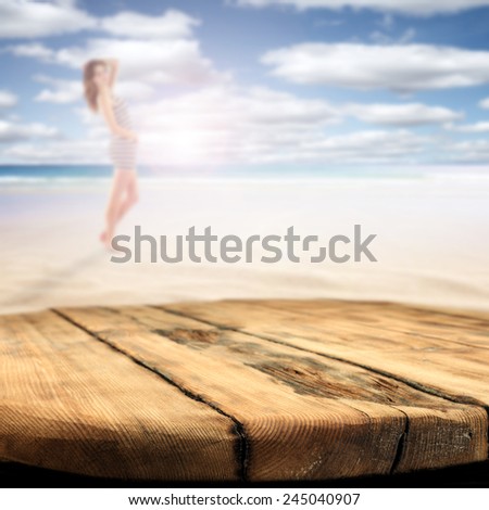 worn old brown table of born color with landscape of sea and sexy woman on the beach