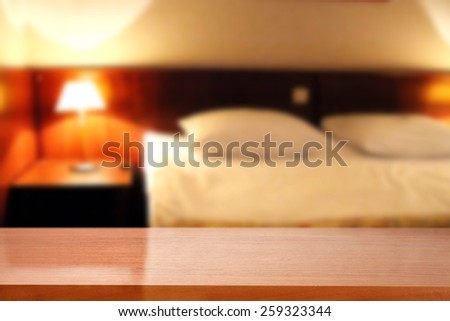 blur background of hotel room and red desk