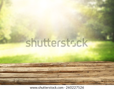 wooden desk space and green landscape of spring time