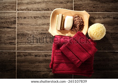 two red towels soap and brown floor