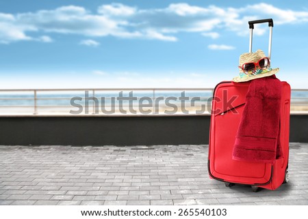 red towel red suitcase and sky of blue