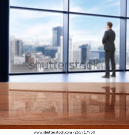 office interior with big window and city landscape and brown desk of free space and boss in black suit