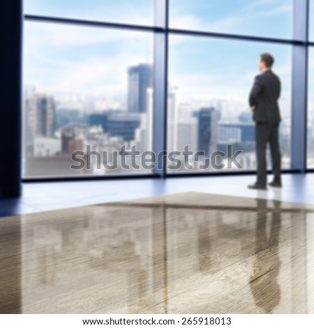 office interior with big window and city landscape and gray desk table and men in suit