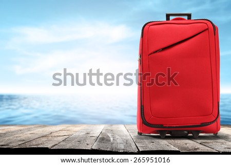 wooden pier suitcase and sea of blue