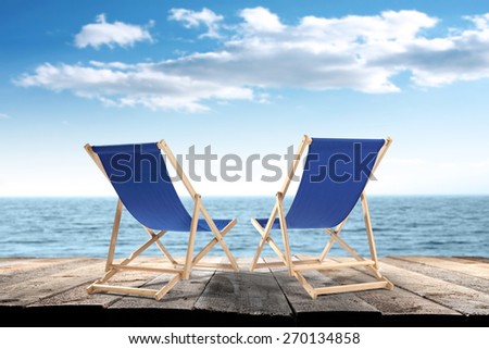 blue chairs and blue sky with sea