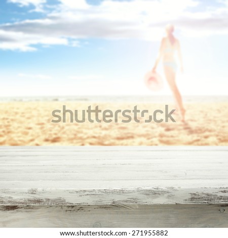 woman in bikini on hot summer sand of beach and white table space
