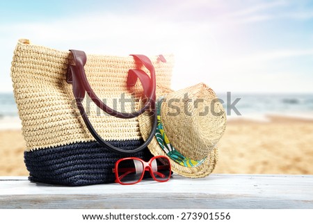 hat big bag and sunglasses on top