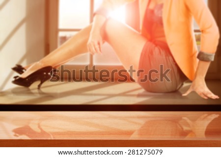 summer sunset with woman on window sill and red desk