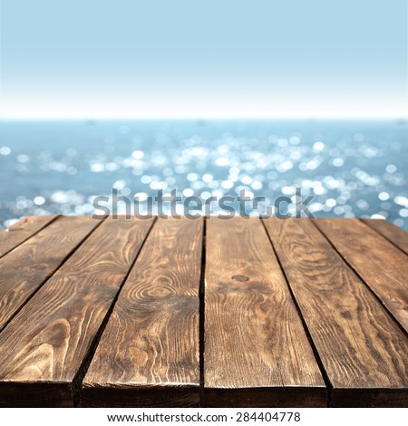 summer blurred sea and sky with brown old table place