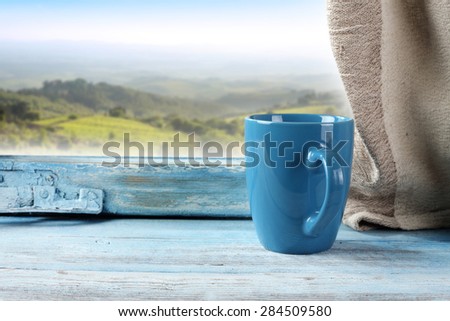 mug of blue color and window of blue