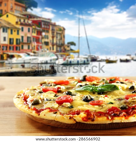 Portofino and pizza on desk