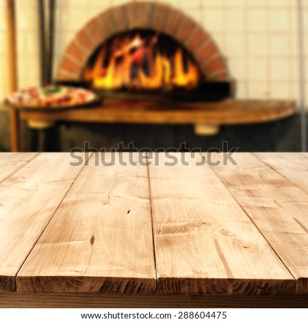 wooden big table of wood fireplace and interior of free space