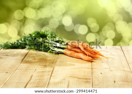 natural blurred background of garden and free space for you on table with carrots