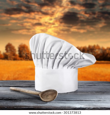 white cook hat board place and spoon of wood